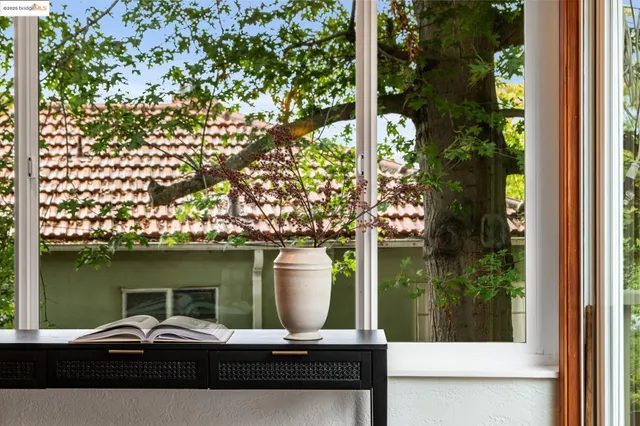 a couple of chairs and a table with potted plants