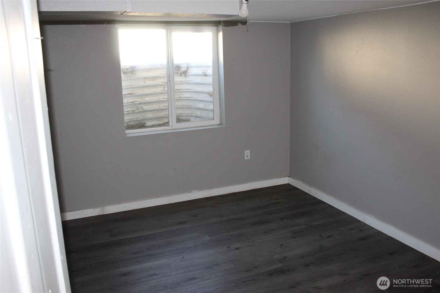 104 East 5th Avenue Ritzville, WA 99169 - Photo 11 of 19 an empty room with wooden floor and windows