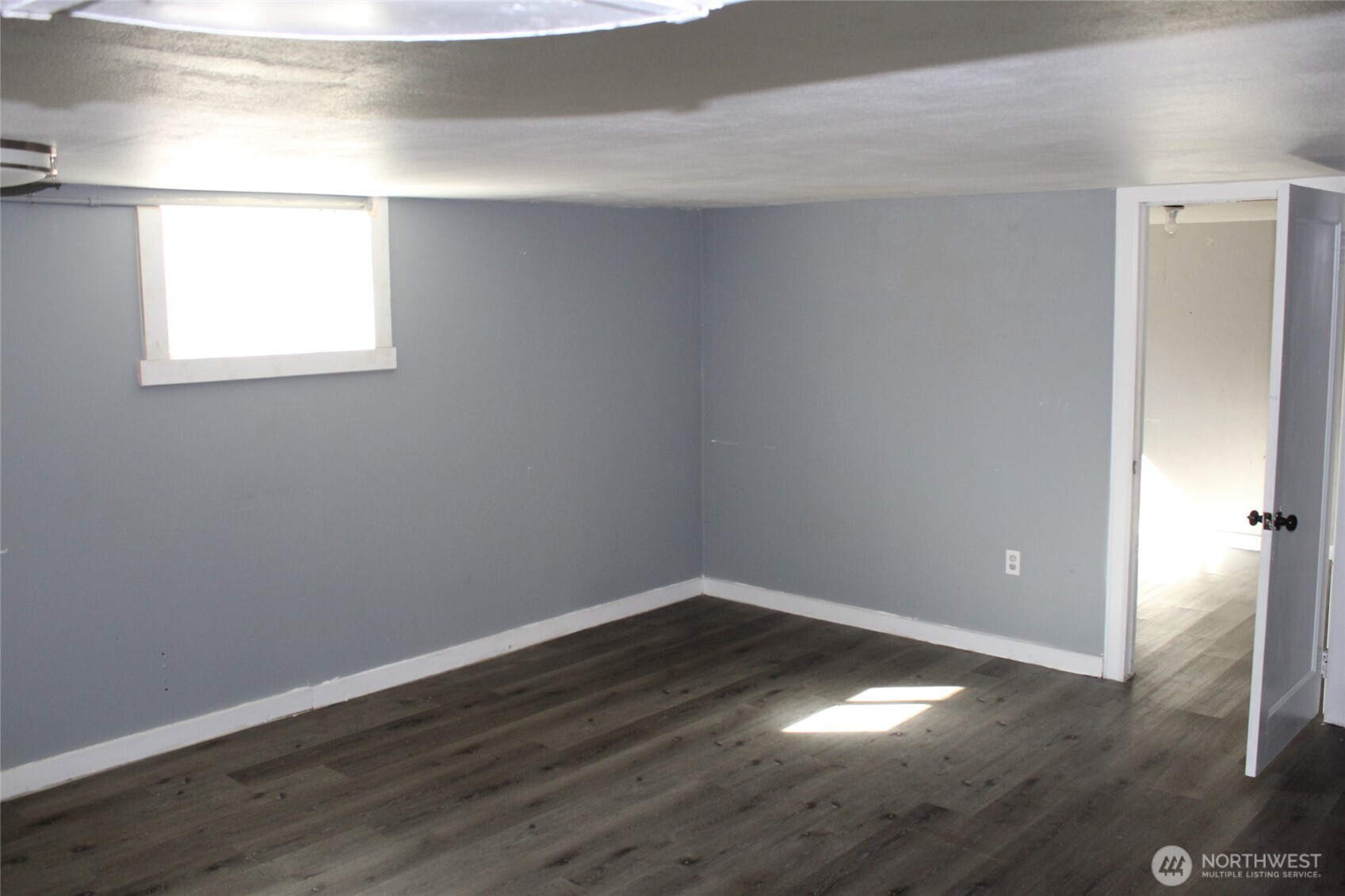 104 East 5th Avenue Ritzville, WA 99169 - Photo 12 of 19 a view of an empty room with wooden floor and a window