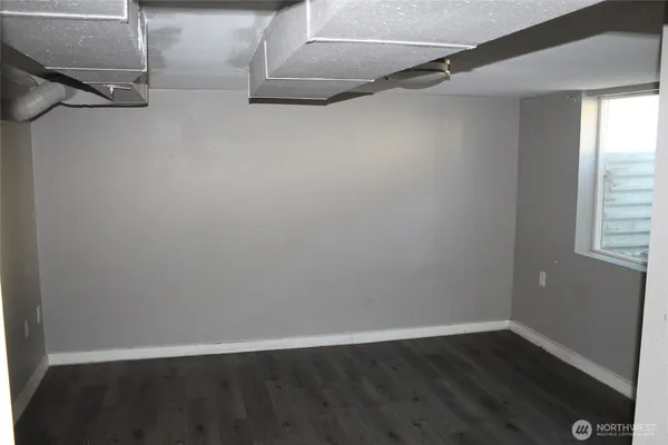 a view of a room with wooden floor