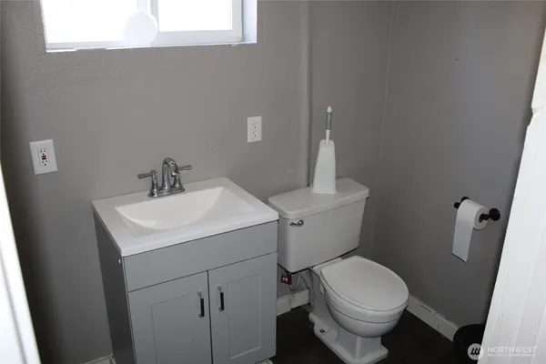 a white toilet sitting next to a bathroom sink
