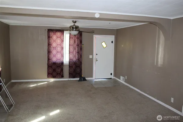 an empty room with windows and closet