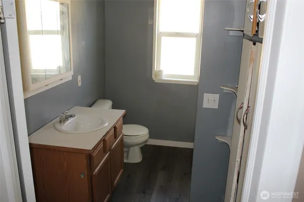 a bathroom with a sink toilet and a window