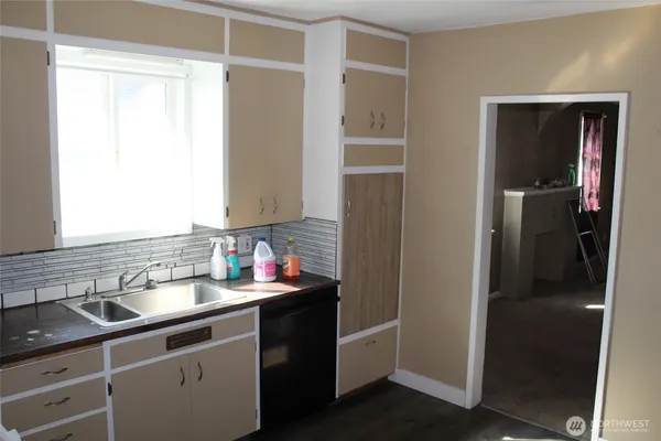 a kitchen with a sink and a refrigerator