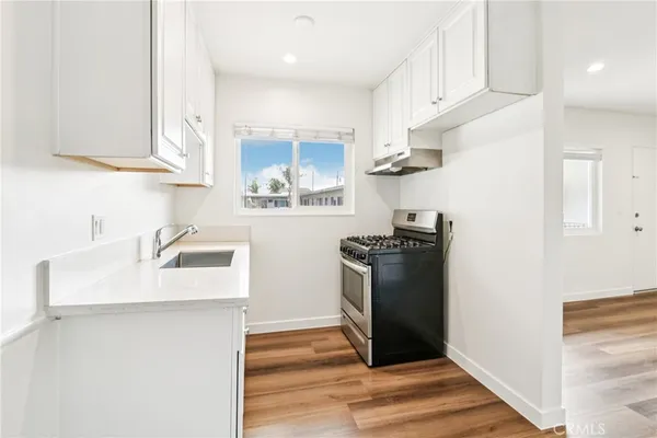 a kitchen with stainless steel appliances granite countertop a refrigerator sink and stove