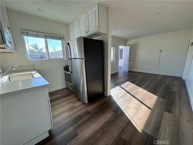 a kitchen with stainless steel appliances a refrigerator and a sink