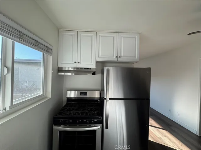 a kitchen with refrigerator and window