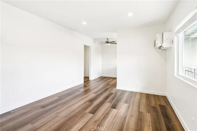 a view of a room with wooden floor and a window