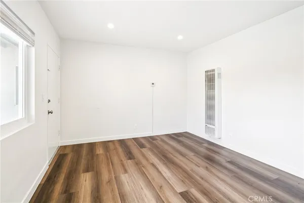 a view of a room with wooden floor and a window