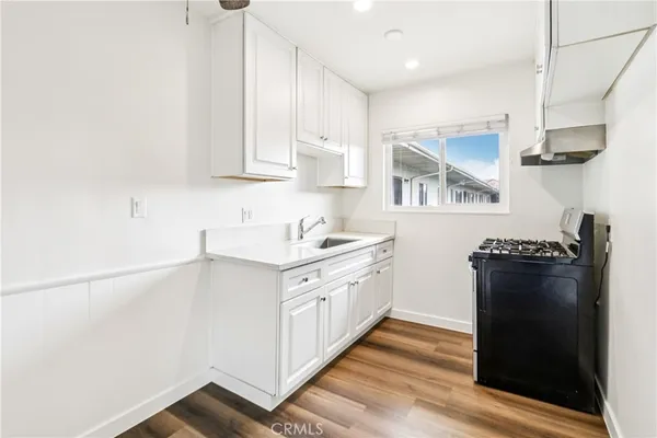 a kitchen with stainless steel appliances granite countertop a refrigerator and a stove