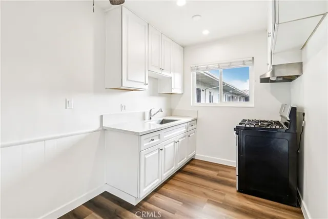 a kitchen with stainless steel appliances granite countertop a refrigerator and a stove