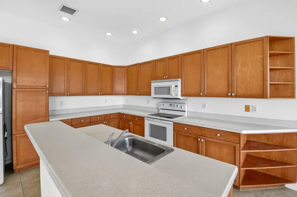 a kitchen with a sink cabinets and stainless steel appliances