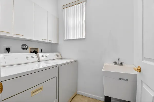 a utility room with a sink dryer and washer
