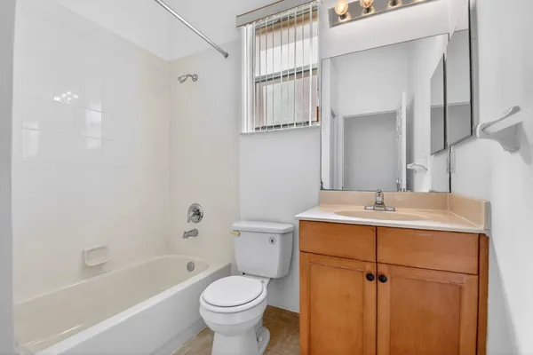 a bathroom with a sink toilet a mirror and shower