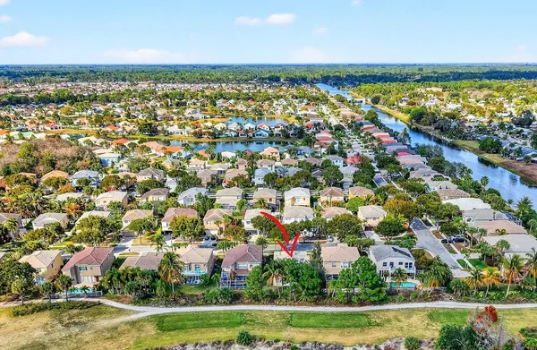 an aerial view of residential building and lake