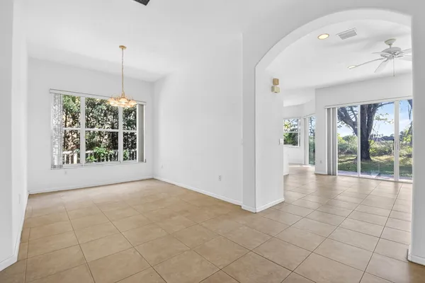 a view of an empty room with glass door and balcony