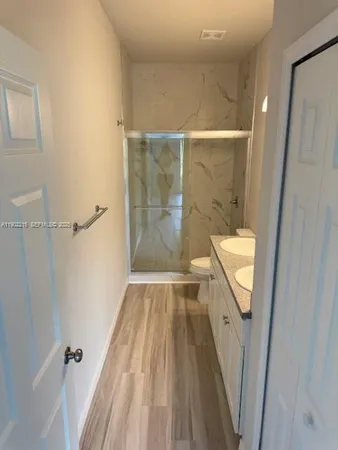 a bathroom with a sink and shower