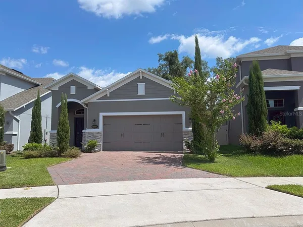a front view of a house with a yard and a garage