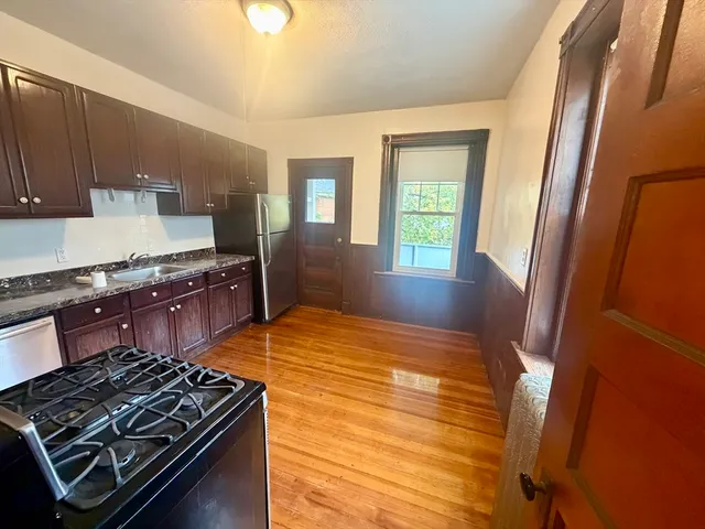a kitchen with stove and cabinets