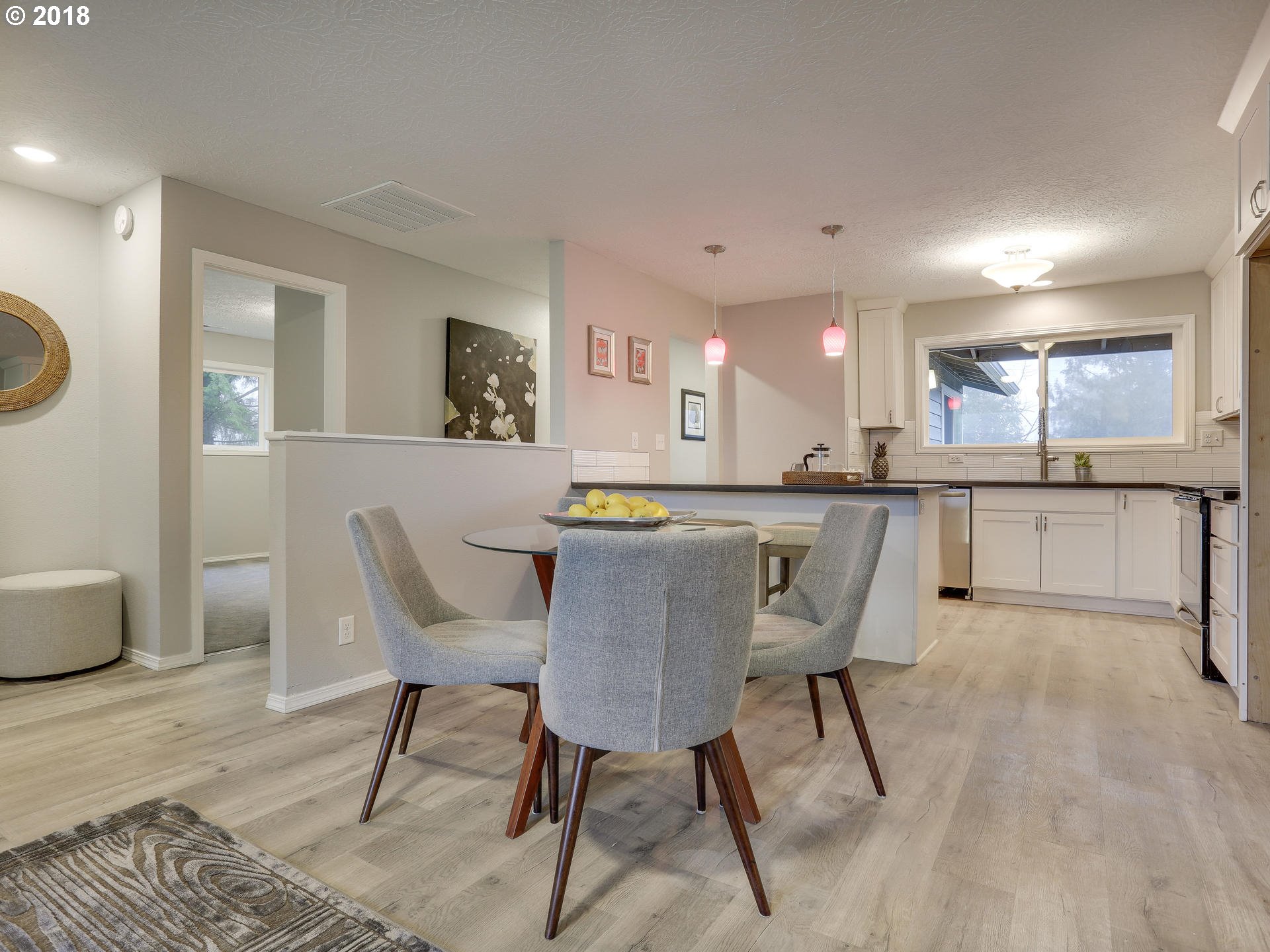 21130 Southeast Foster Road Damascus, OR 97089 - Photo 12 of 30 a kitchen with stainless steel appliances granite countertop a sink a stove a dining table and chairs