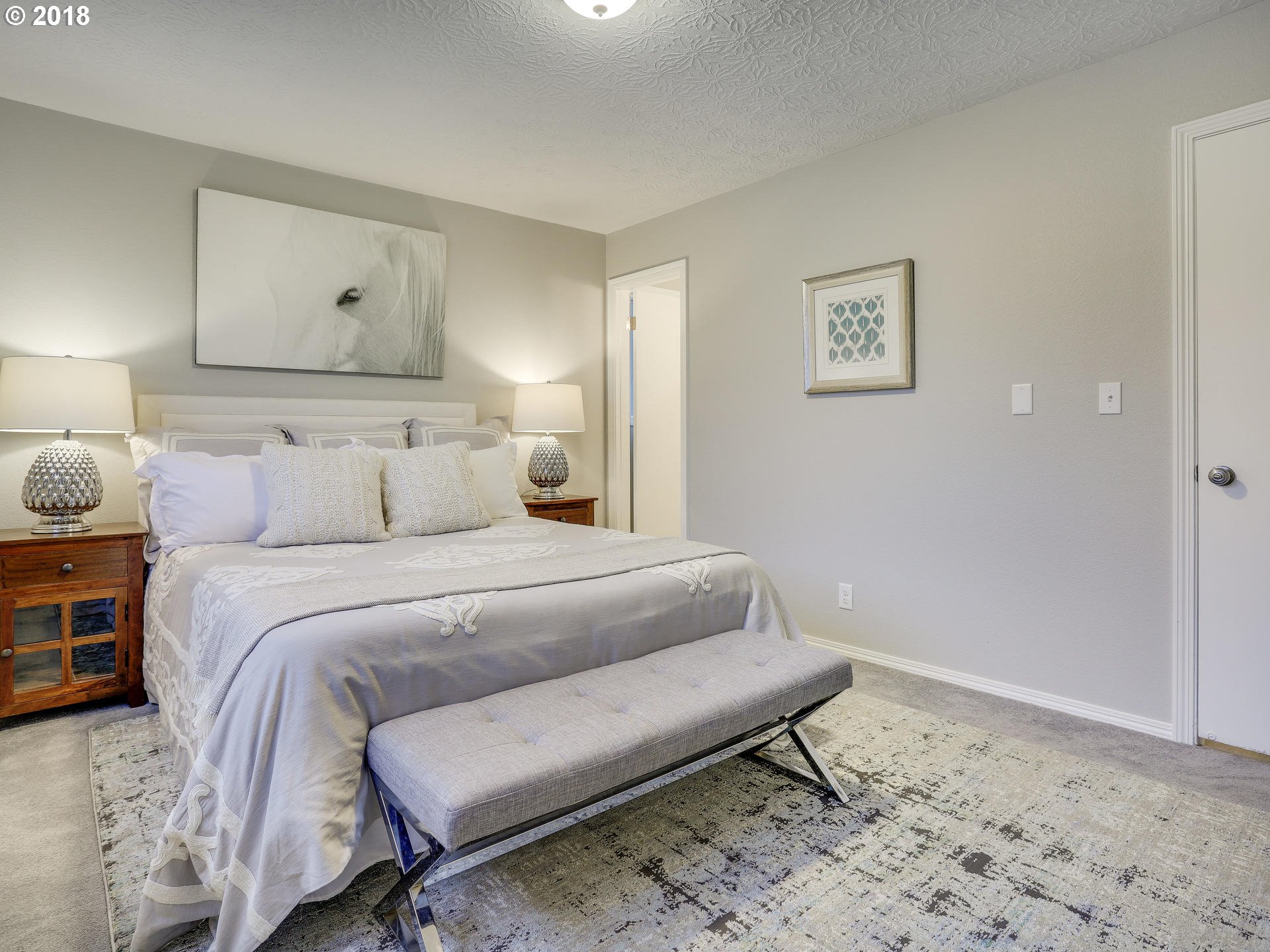 21130 Southeast Foster Road Damascus, OR 97089 - Photo 19 of 30 a bedroom with a bed and a lamp