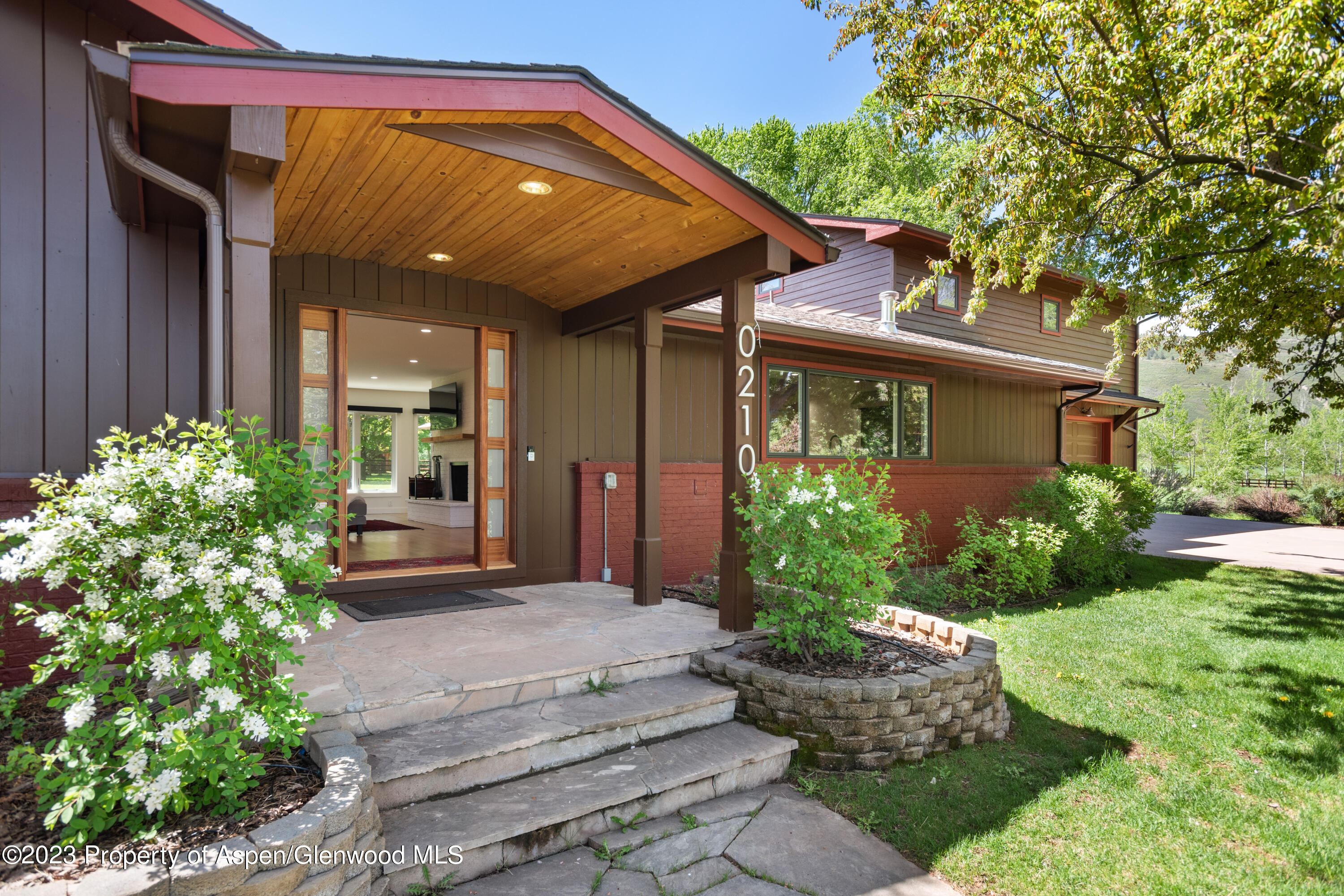 210 Horseshoe Drive Basalt, CO 81621 - Photo 2 of 52 a view of a house with potted plants and a bench