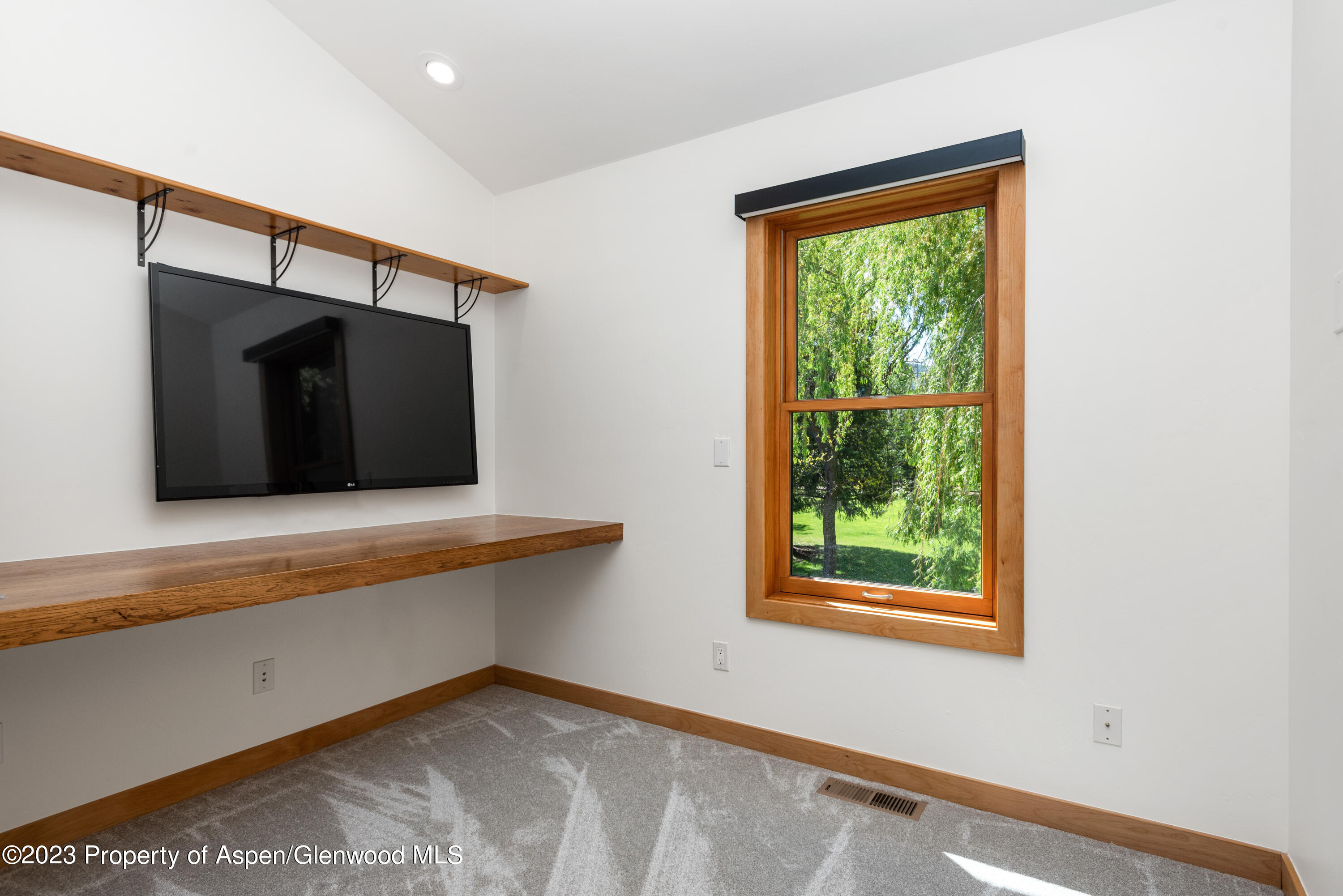 210 Horseshoe Drive Basalt, CO 81621 - Photo 21 of 52 a view of an empty room with wooden floor and a window