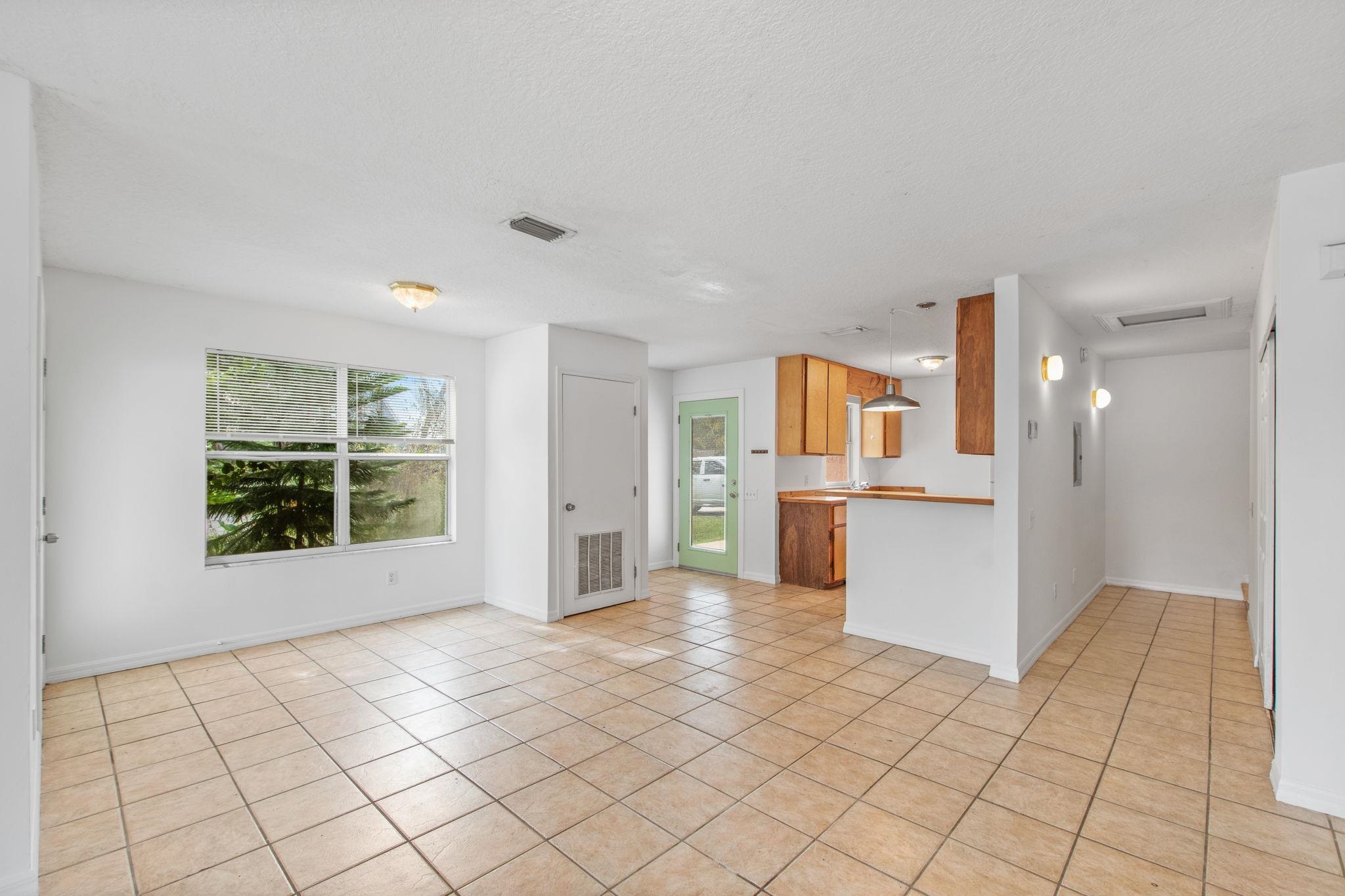 a view of a kitchen with furniture and an empty room