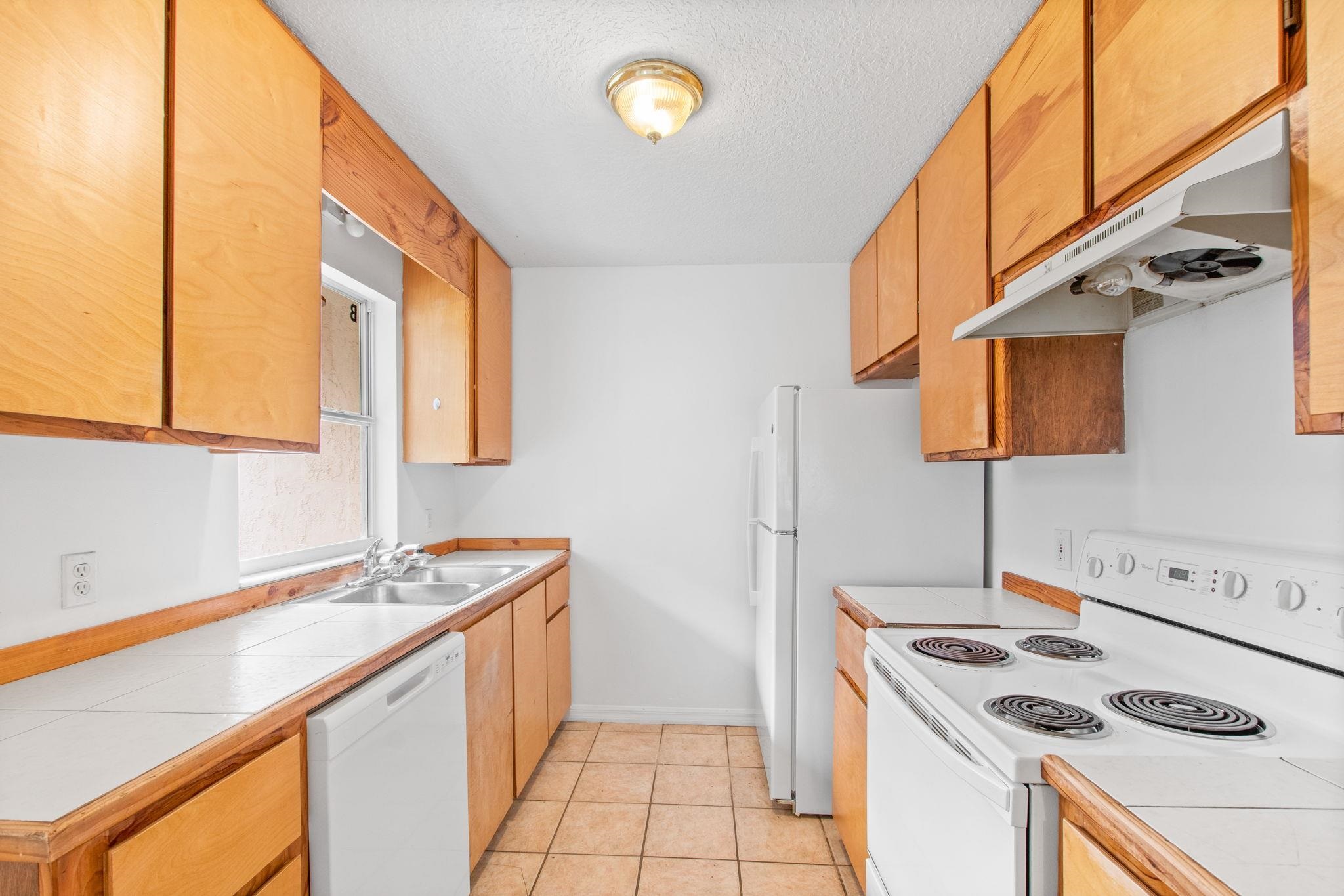 202 F Street St. Augustine, FL 32080 - Photo 11 of 28 a kitchen that has a sink and a stove