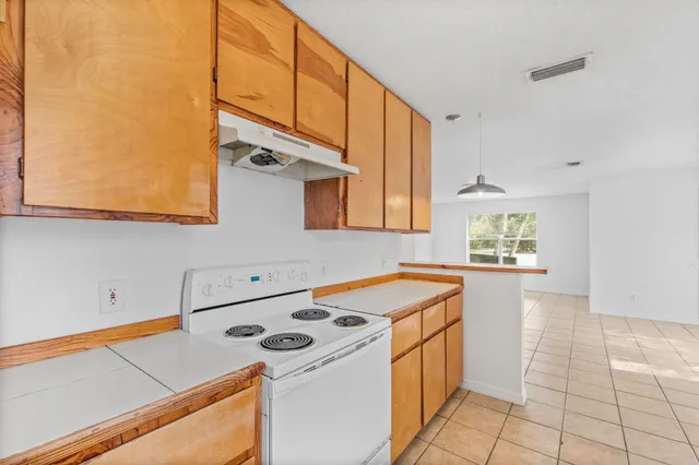 a view of a room with a sink and a mirror
