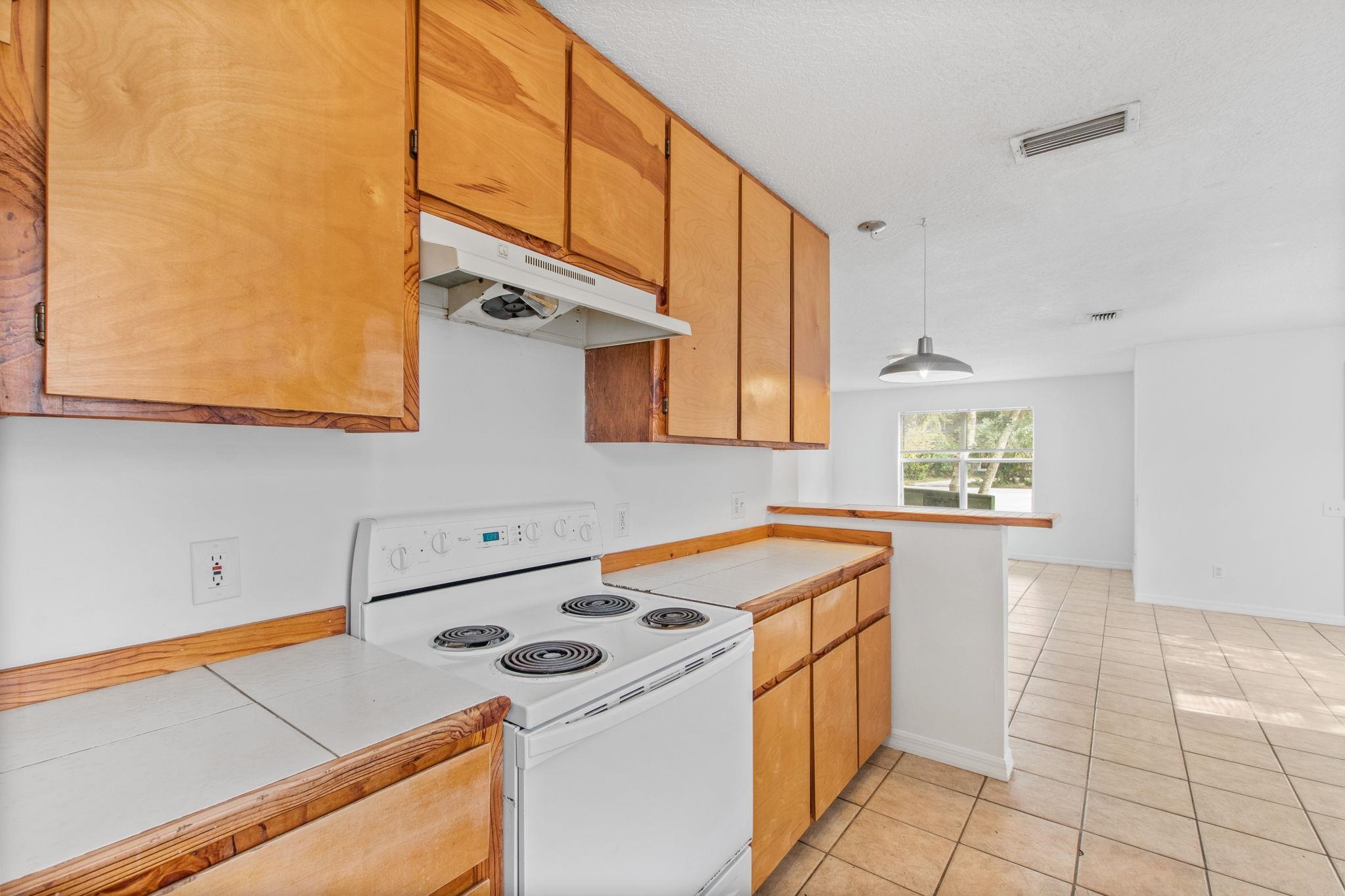 202 F Street St. Augustine, FL 32080 - Photo 12 of 28 a kitchen that has a sink a stove and a microwave oven