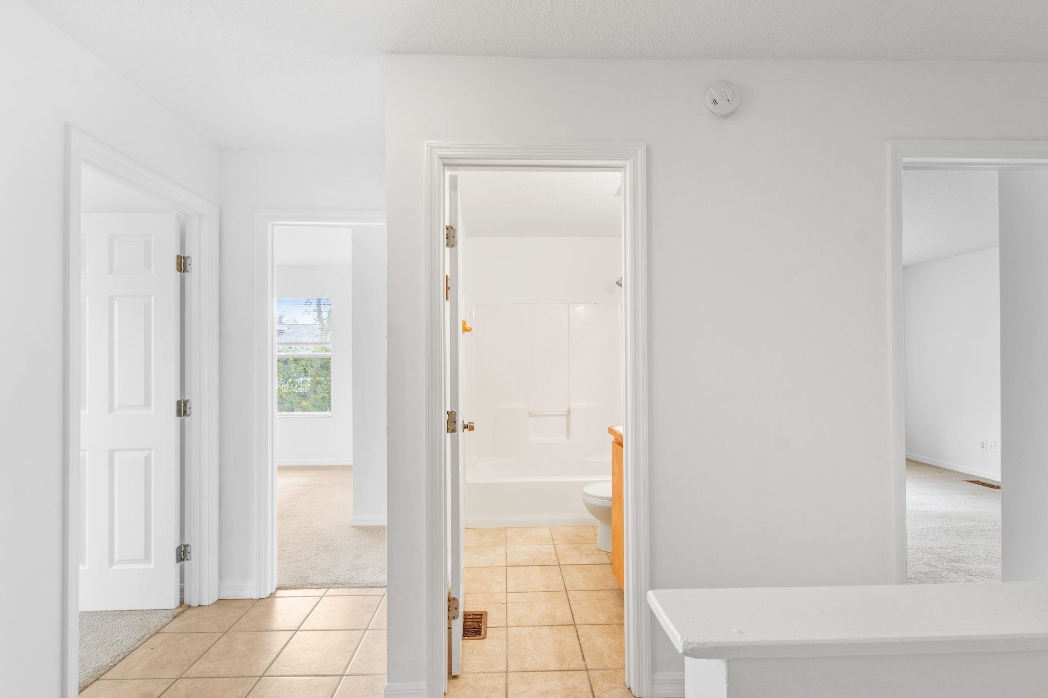 202 F Street St. Augustine, FL 32080 - Photo 17 of 28 a bathroom with a glass shower door