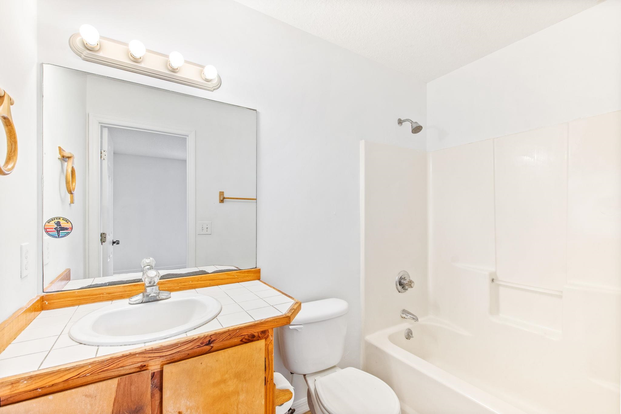 202 F Street St. Augustine, FL 32080 - Photo 22 of 28 a bathroom with a granite countertop sink and a bathtub