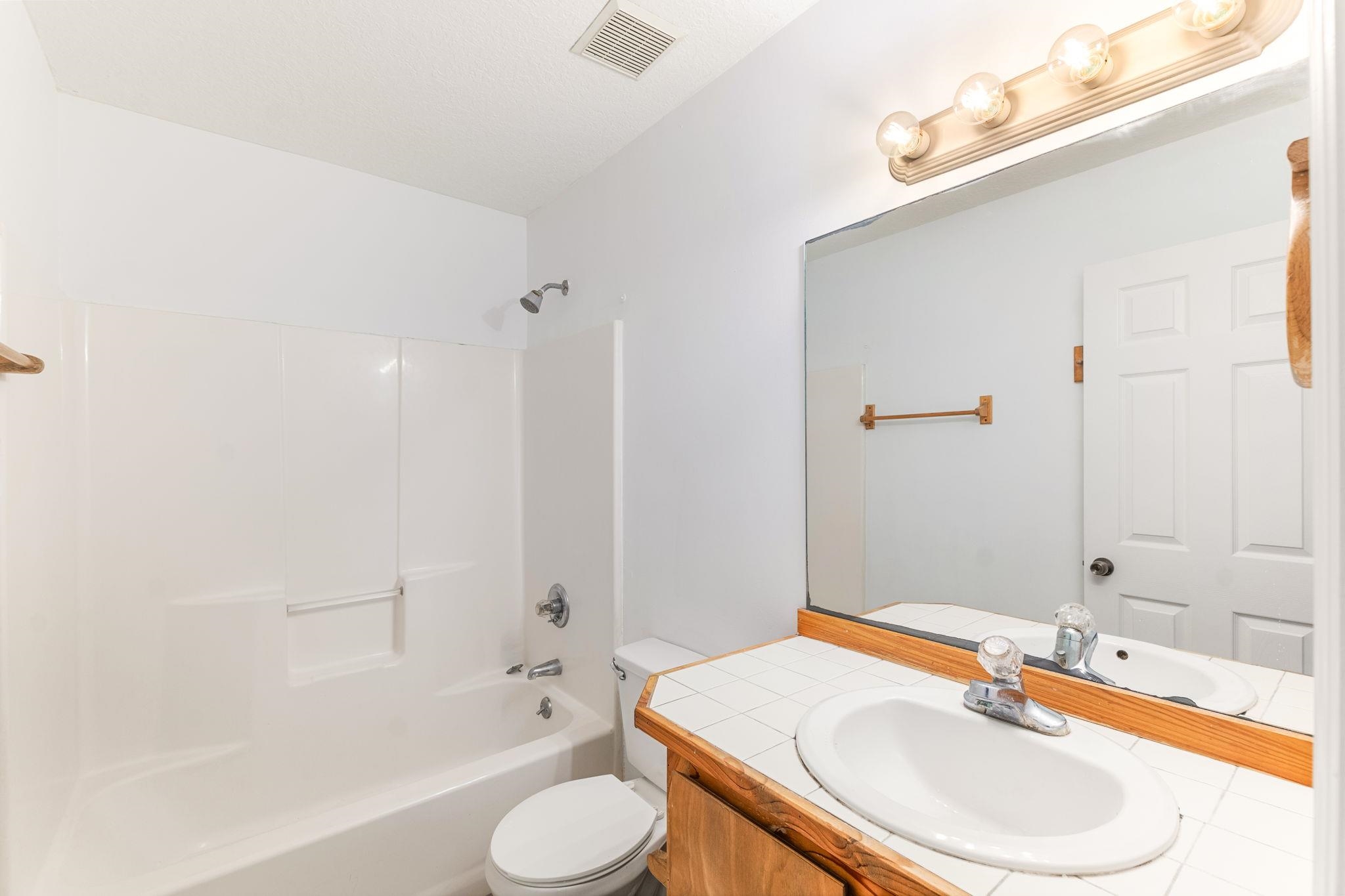 202 F Street St. Augustine, FL 32080 - Photo 25 of 28 a bathroom with a sink and a mirror