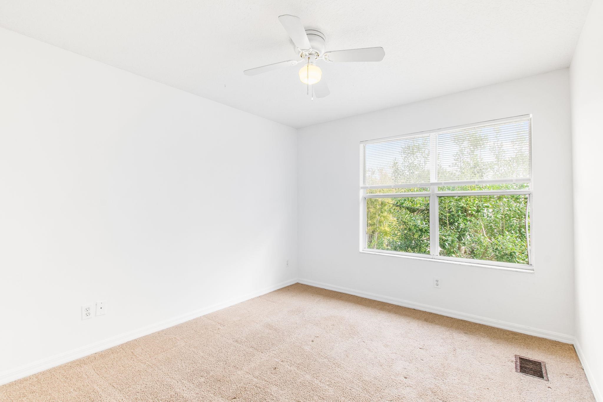 202 F Street St. Augustine, FL 32080 - Photo 26 of 28 an empty room with a window and a fan