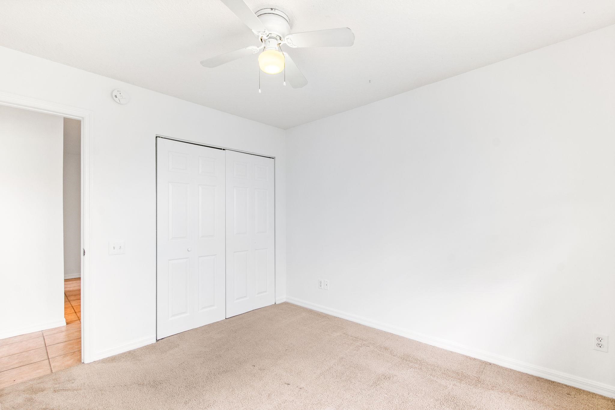 202 F Street St. Augustine, FL 32080 - Photo 27 of 28 an empty room with a ceiling fan and a window