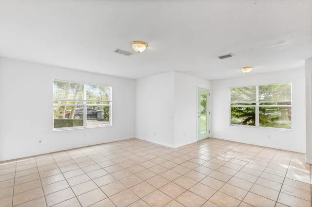 a view of a kitchen with furniture and an empty room