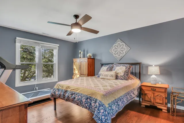 a bedroom with a bed chandelier and a window