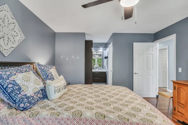a bedroom with a large bed and a chandelier