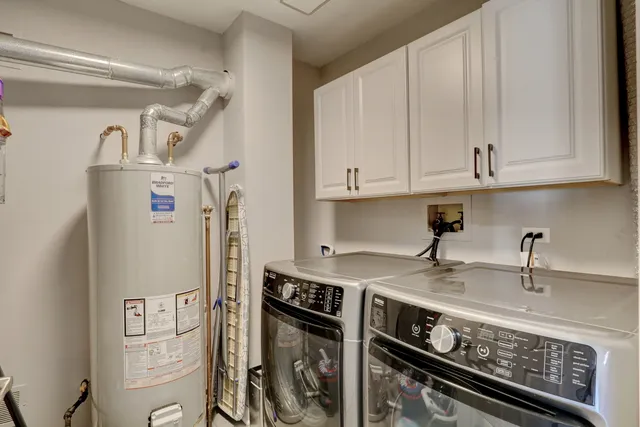 a kitchen with stainless steel appliances a refrigerator a sink and cabinets