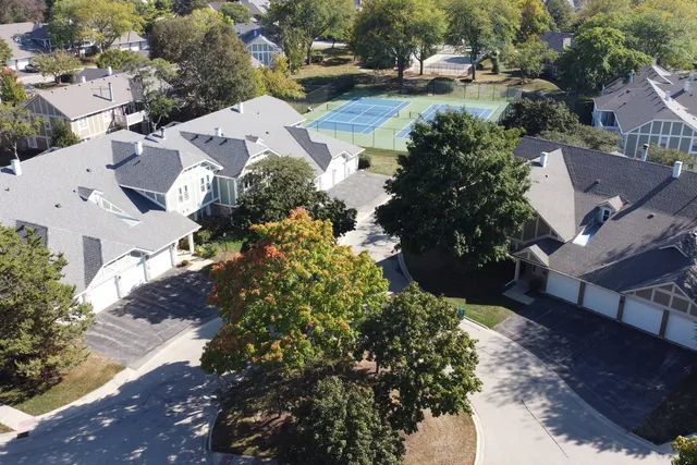 an aerial view of multiple houses with yard
