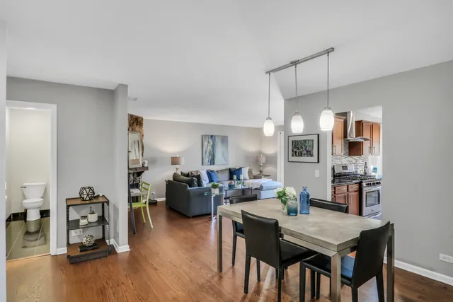 a living room with furniture a dining table with wooden floor