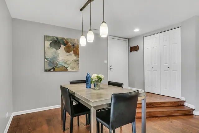 a dining room with furniture and wooden floor