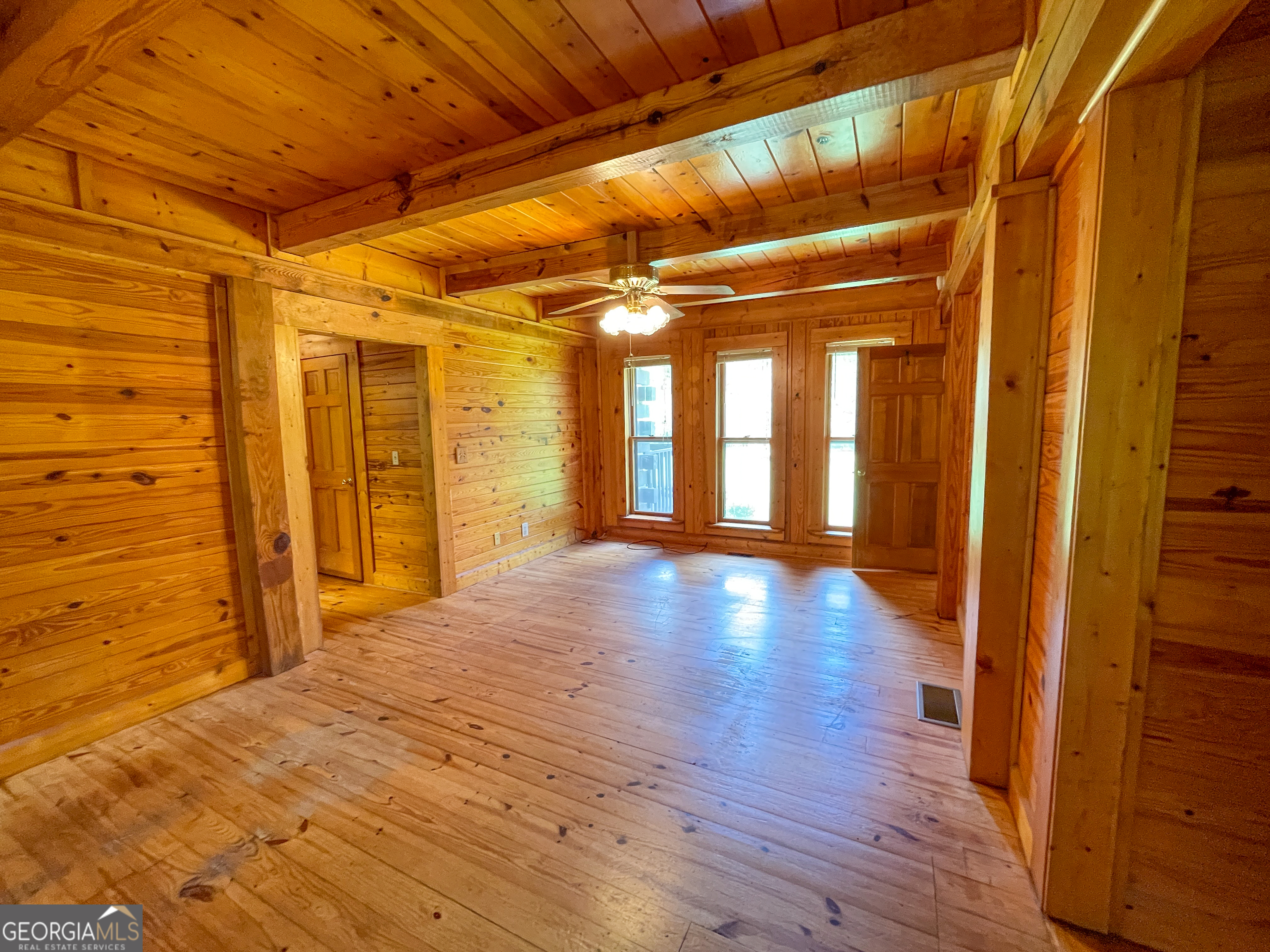 305 West Drive Roopville, GA 30170 - Photo 25 of 70 a view of an empty room with wooden floor and a window