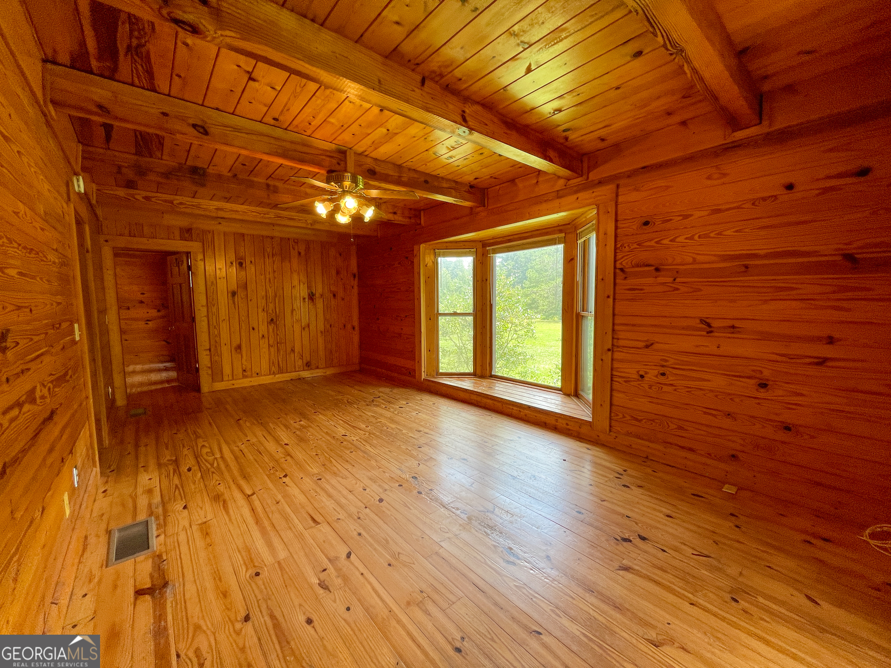 305 West Drive Roopville, GA 30170 - Photo 26 of 70 a view of an empty room with wooden floor and a window