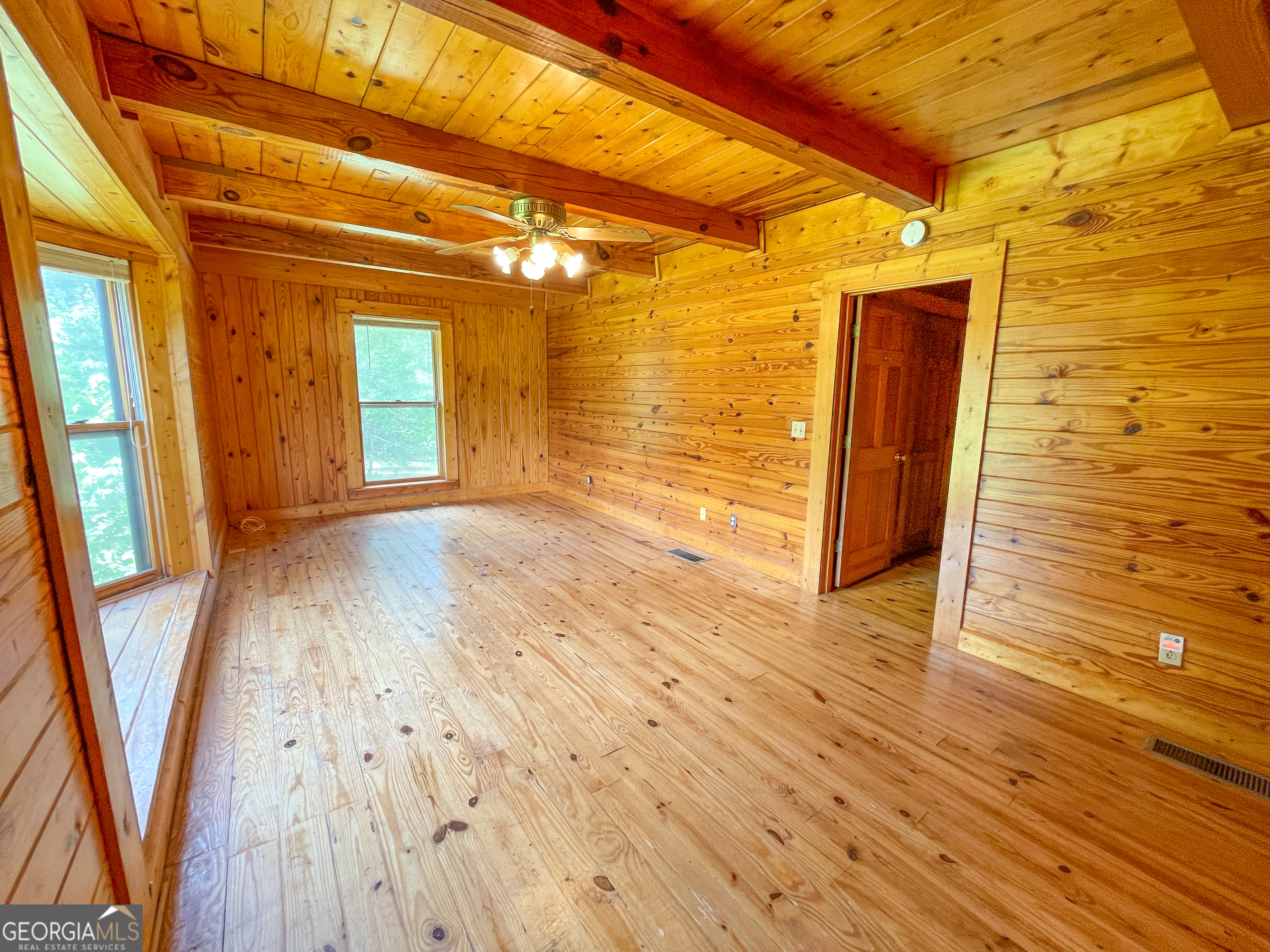 305 West Drive Roopville, GA 30170 - Photo 27 of 70 a view of an empty room with wooden floor and a window