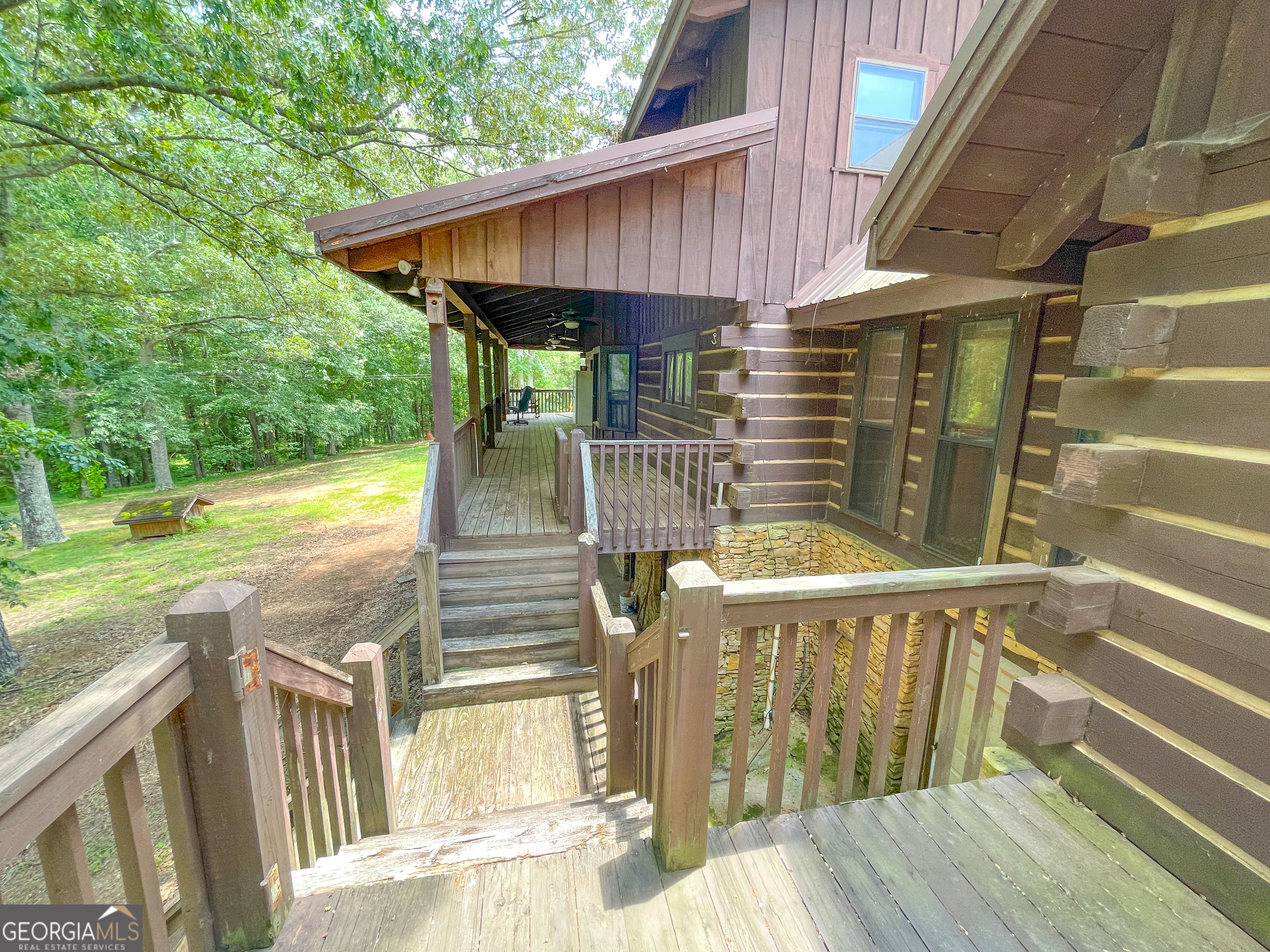 305 West Drive Roopville, GA 30170 - Photo 57 of 70 a view of a balcony with floor to ceiling window wooden floor and fence