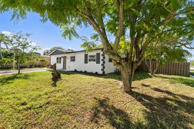a house with a tree in front of it