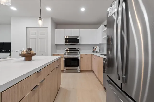 a kitchen with stainless steel appliances sink a microwave and cabinets