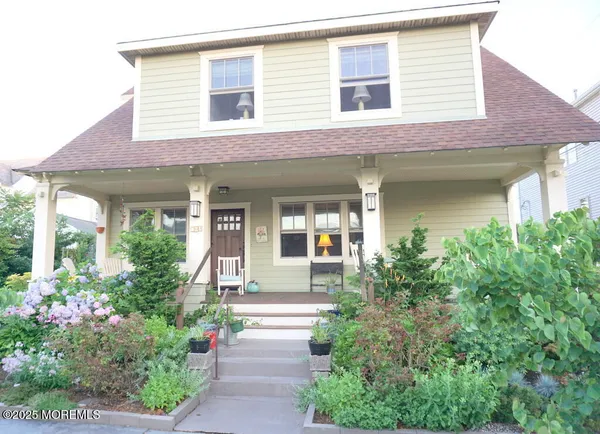 front view of a house with potted plants